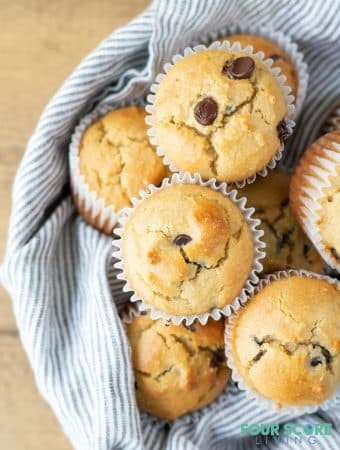 a close up of Low Carb Chocolate Chip Muffins in a bowl with a striped towel.