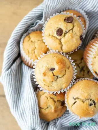 a close up of Low Carb Chocolate Chip Muffins in a bowl with a striped towel.