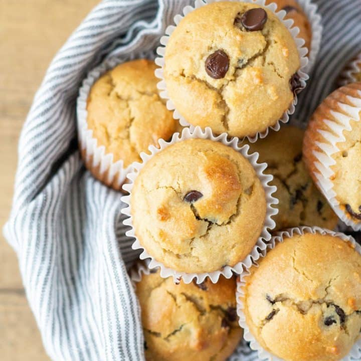 a close up of Low Carb Chocolate Chip Muffins in a bowl with a striped towel.