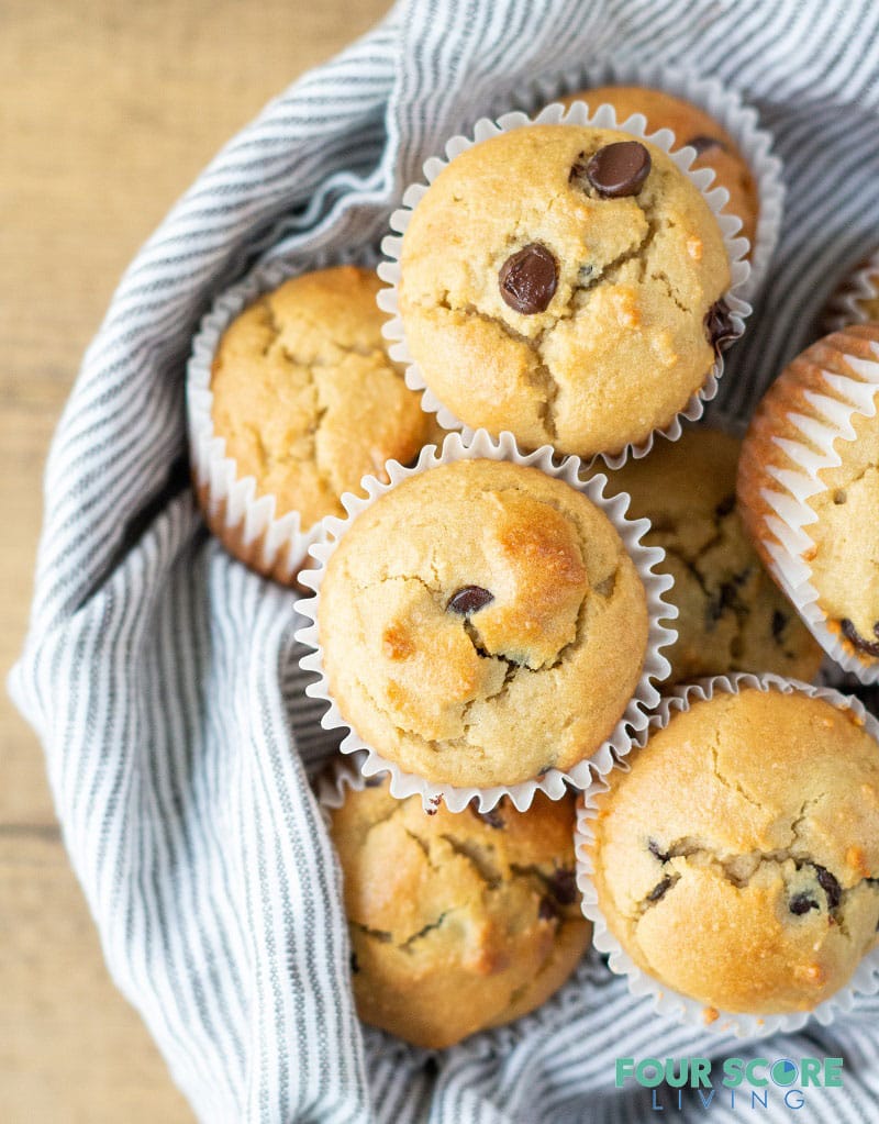 Low Carb Chocolate Chip Muffins in a bowl with a striped towel.