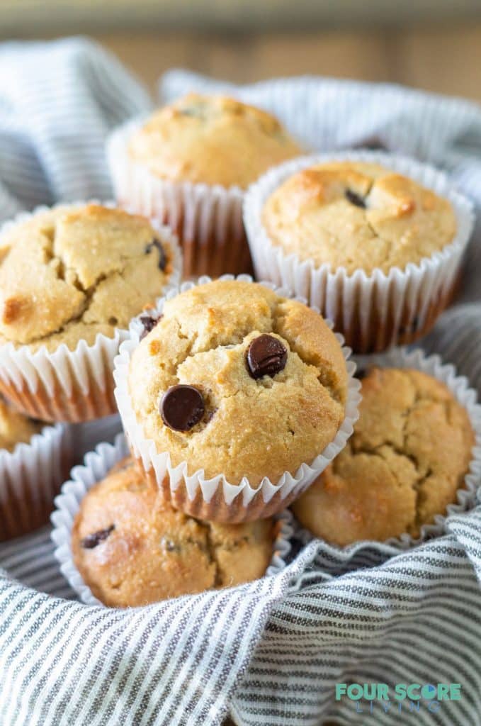 a side view of Low Carb Chocolate Chip Muffins in a bowl with a striped towel