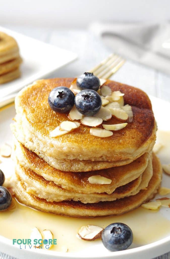 Stack of low carb pancakes topped with blueberries and sliced almonds