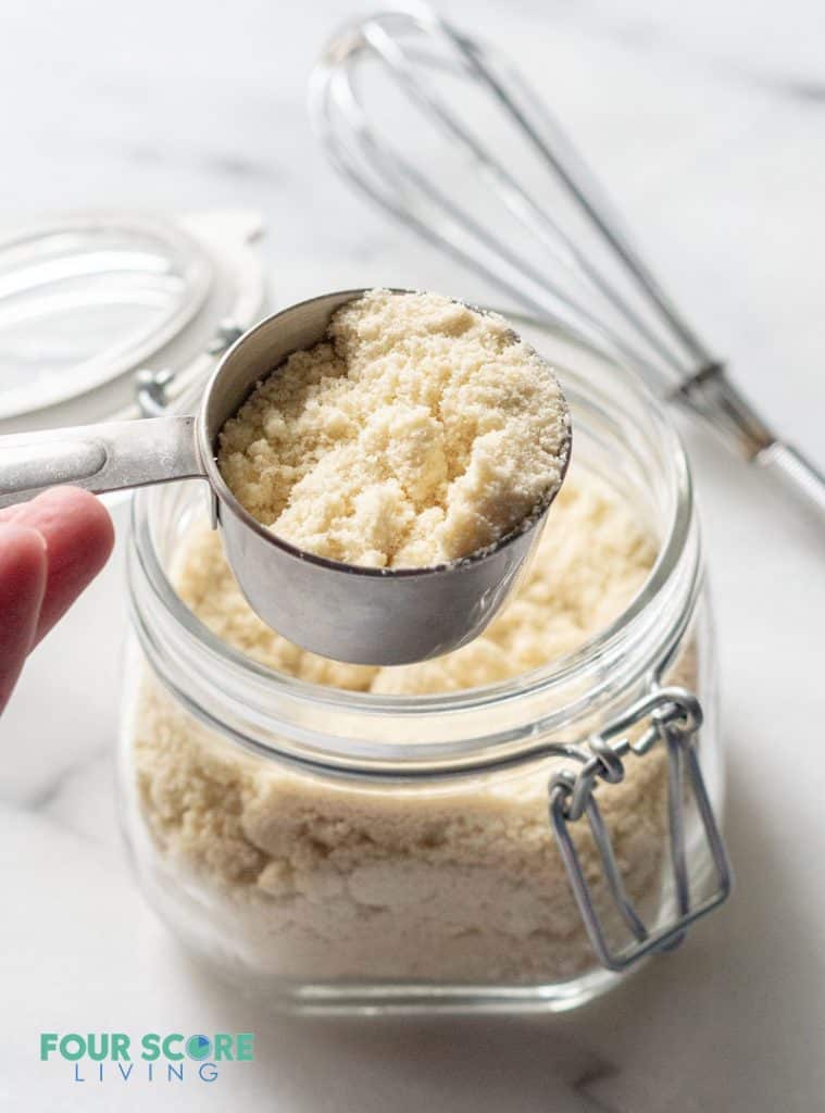 a mesuring cup filled with almond flour for making low carb pancakes