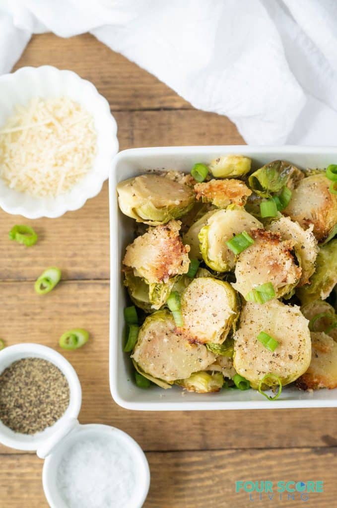 a top down view of Parmesan Roasted Brussels Sprouts in a white bowl.