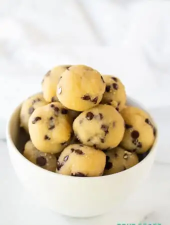a close up of keto cookie dough bites in a white bowl