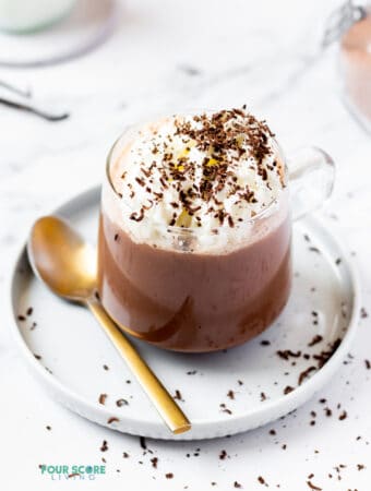 keto hot chocolate in a clear mug topped with whipped cream