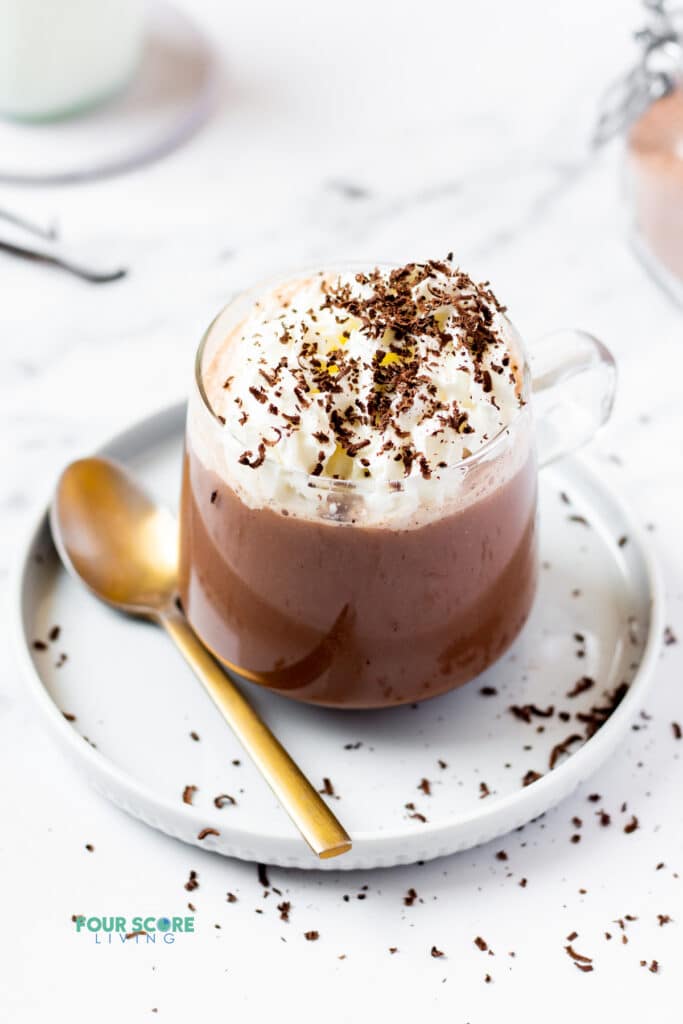 keto hot chocolate in a clear mug topped with whipped cream