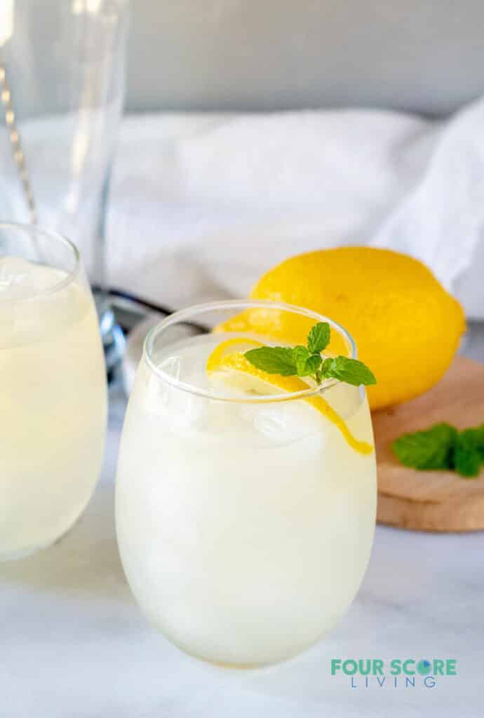 keto lemonade in a glass with lemon and mint with a lemon in the background