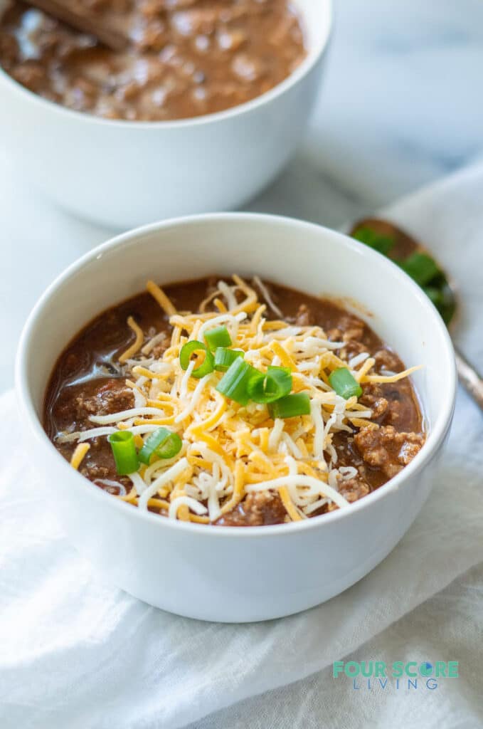 keto chili in a white bowl with cheese