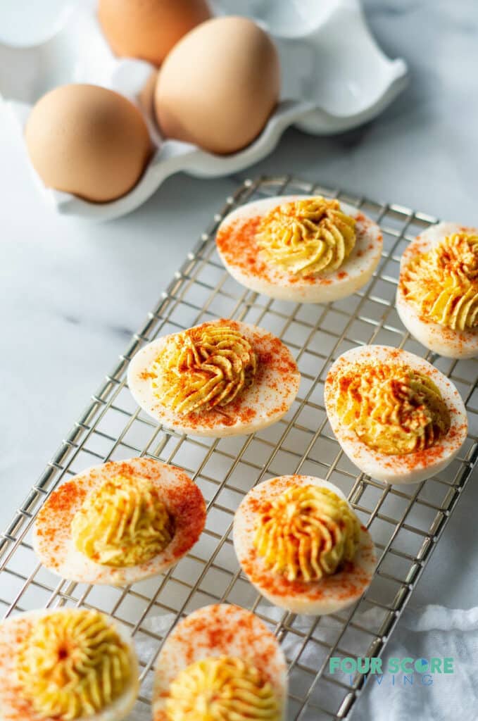 keto deviled eggs on a wire rack with paprika on top