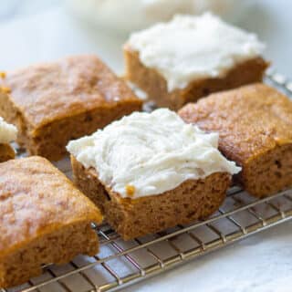 keto pumpkin bars on a wire rack with frosting