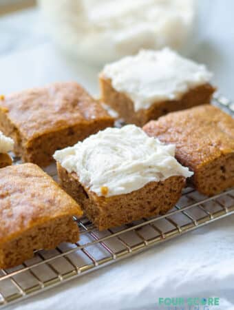 keto pumpkin bars on a wire rack with frosting