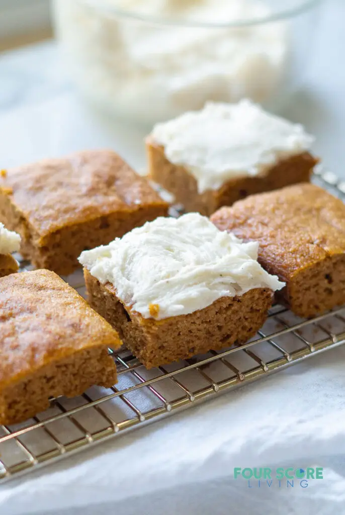keto pumpkin bars on a wire rack with frosting