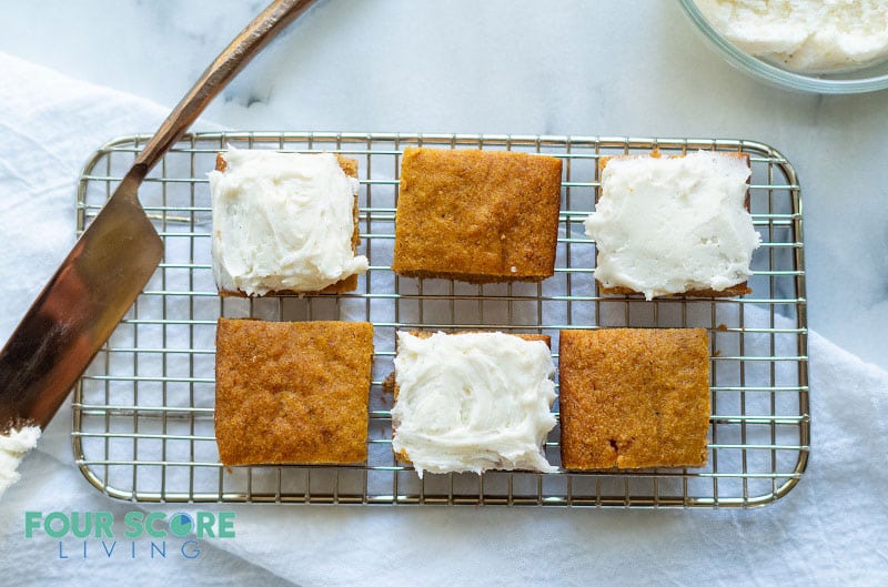 keto pumpkin bars on a wire rack with frosting