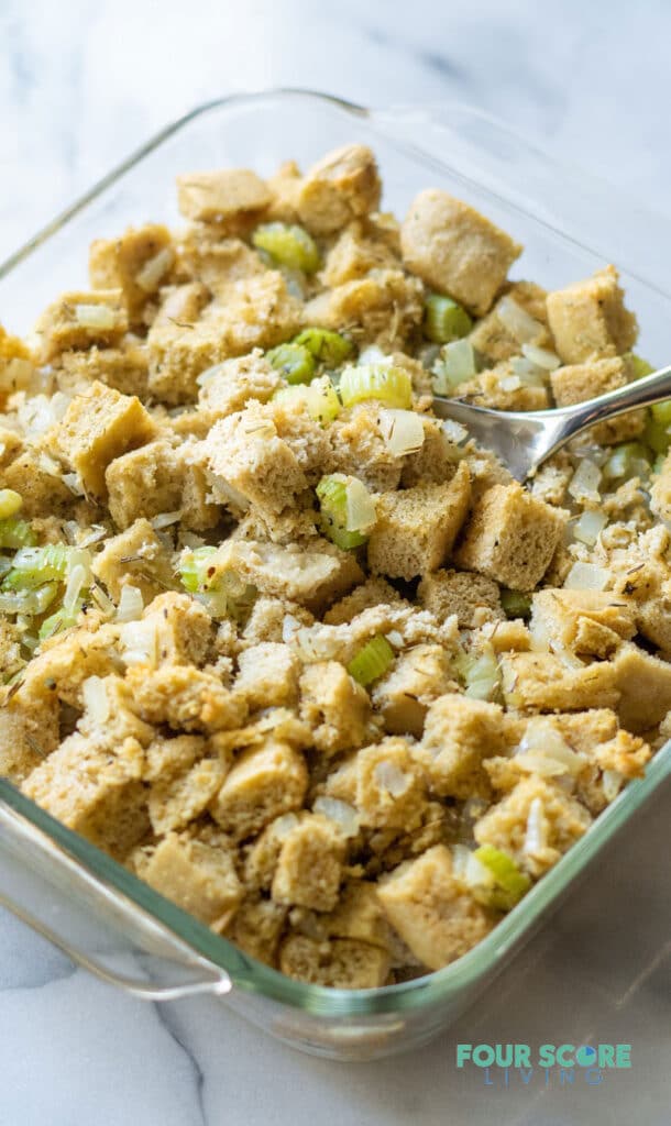 keto stuffing in a glass pan with a spoon