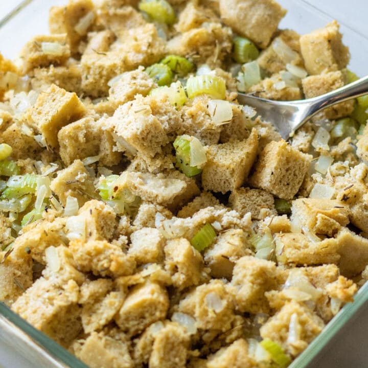 a close up of keto stuffing in a glass pan with a spoon