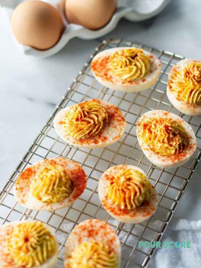 keto deviled eggs on a wire rack with paprika on top