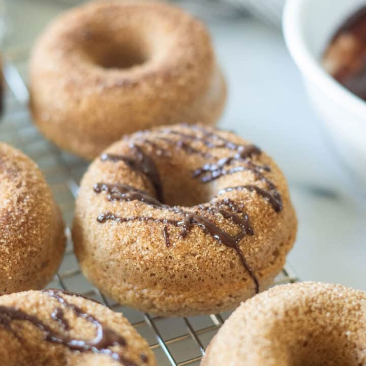keto cinnamon sugar donuts with a chocolate drizzle