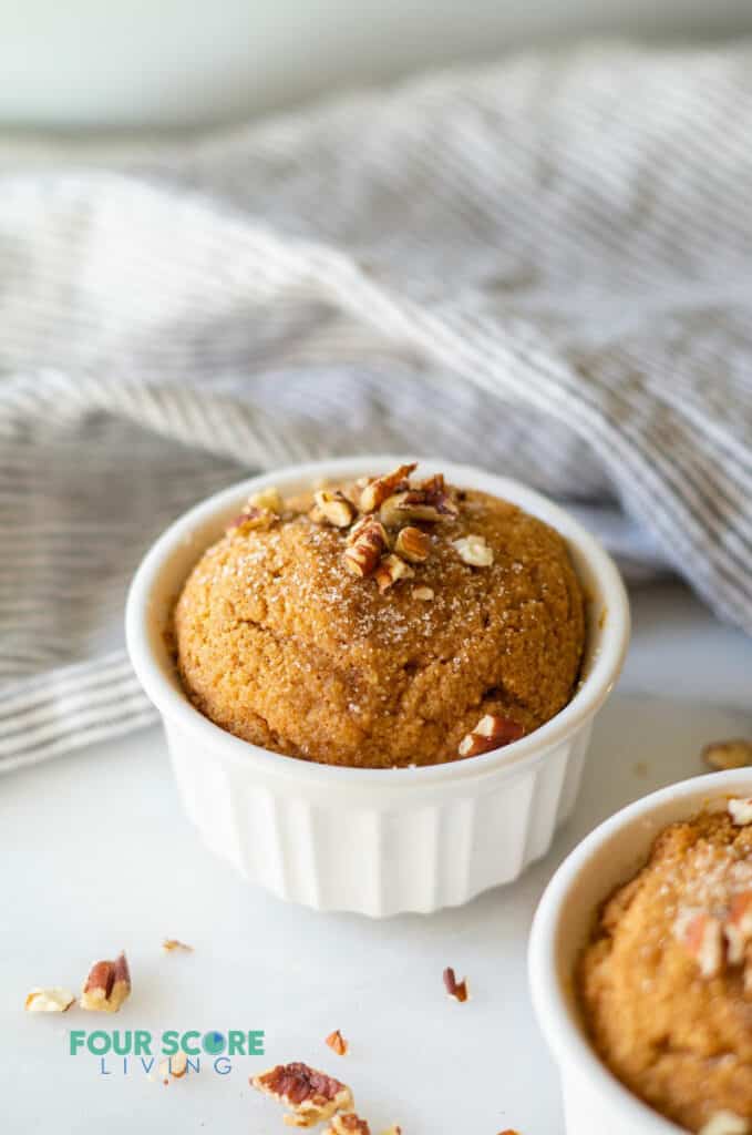 keto pumpkin mug cake with a hand towel