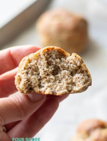 hand holding a keto roll with a bite out