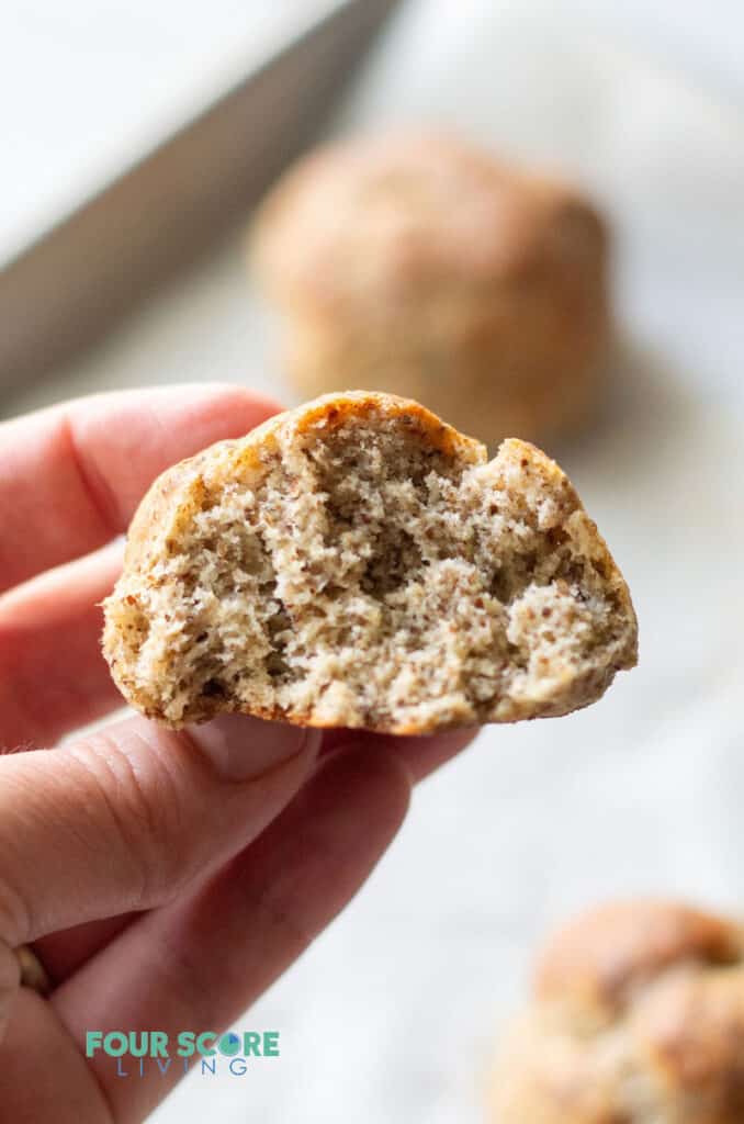 hand holding a keto roll with a bite out