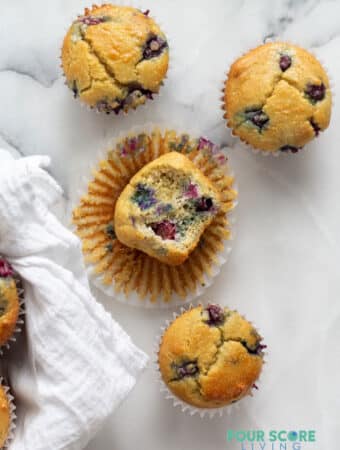four keto blueberry muffins on a white background