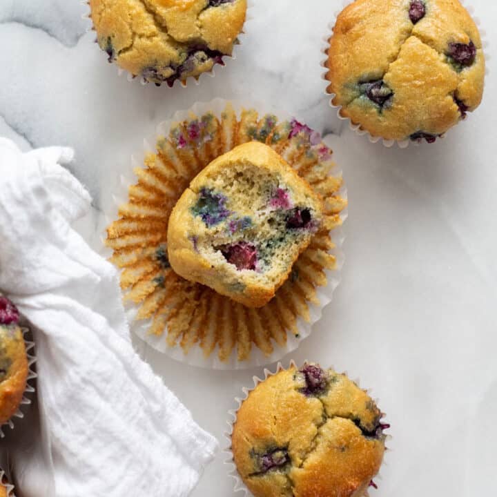 four keto blueberry muffins on a white background