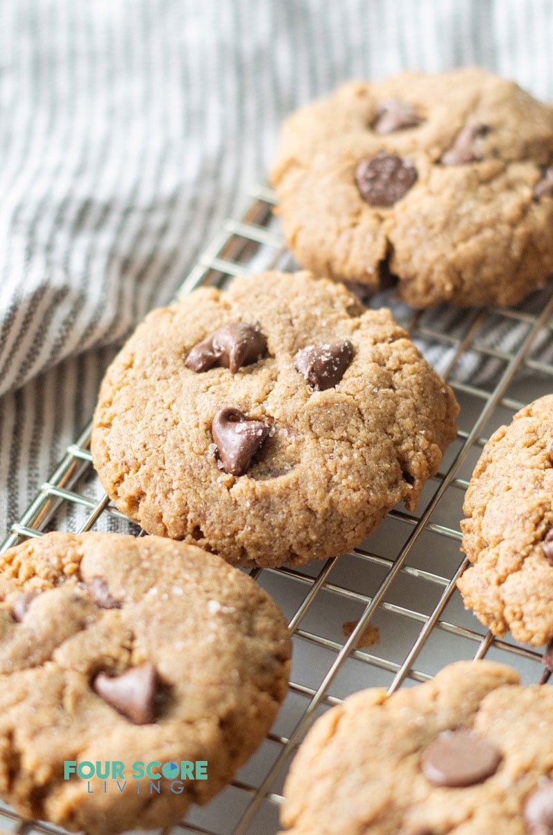 keto almond butter cookies on a wire rack over a striped gray towel