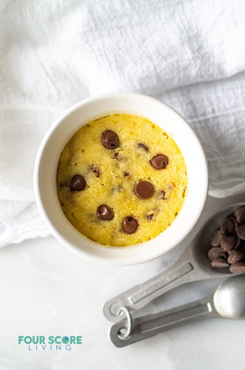 a small white dish with a chocolate studded dessert inside