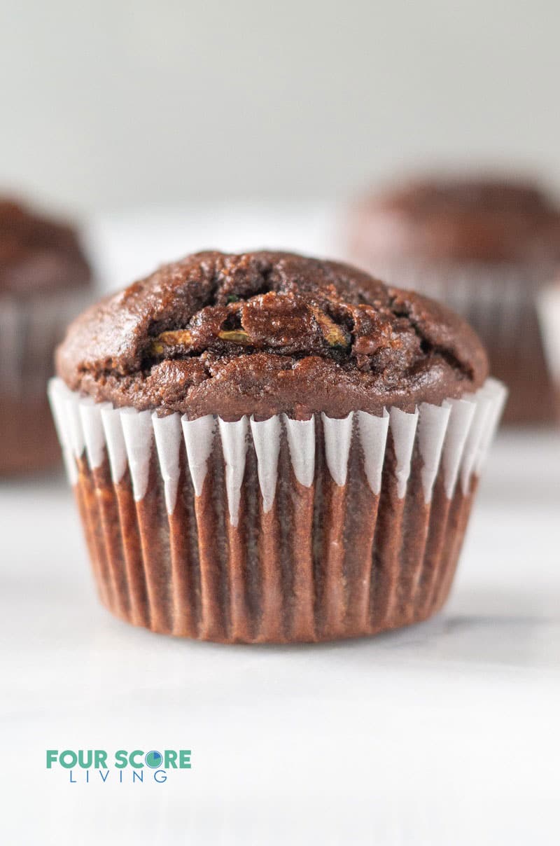 a chocolate muffin in a white cupcake liner