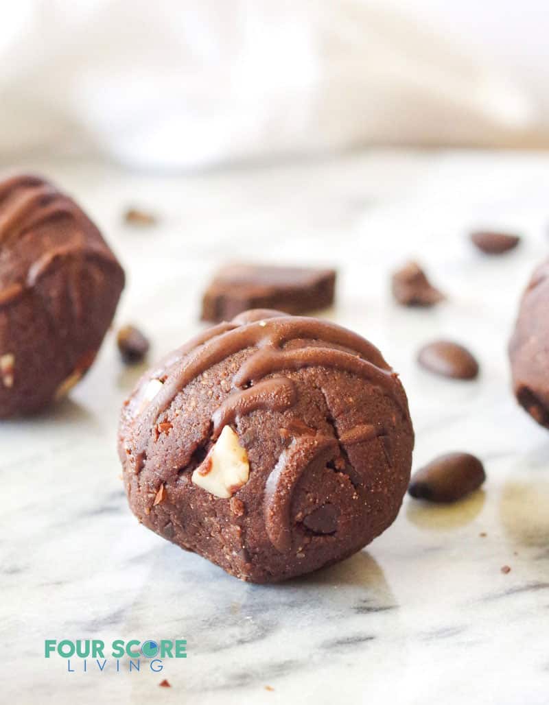 a round chocolate ball studded with sliced almonds and drizzled with chocolate