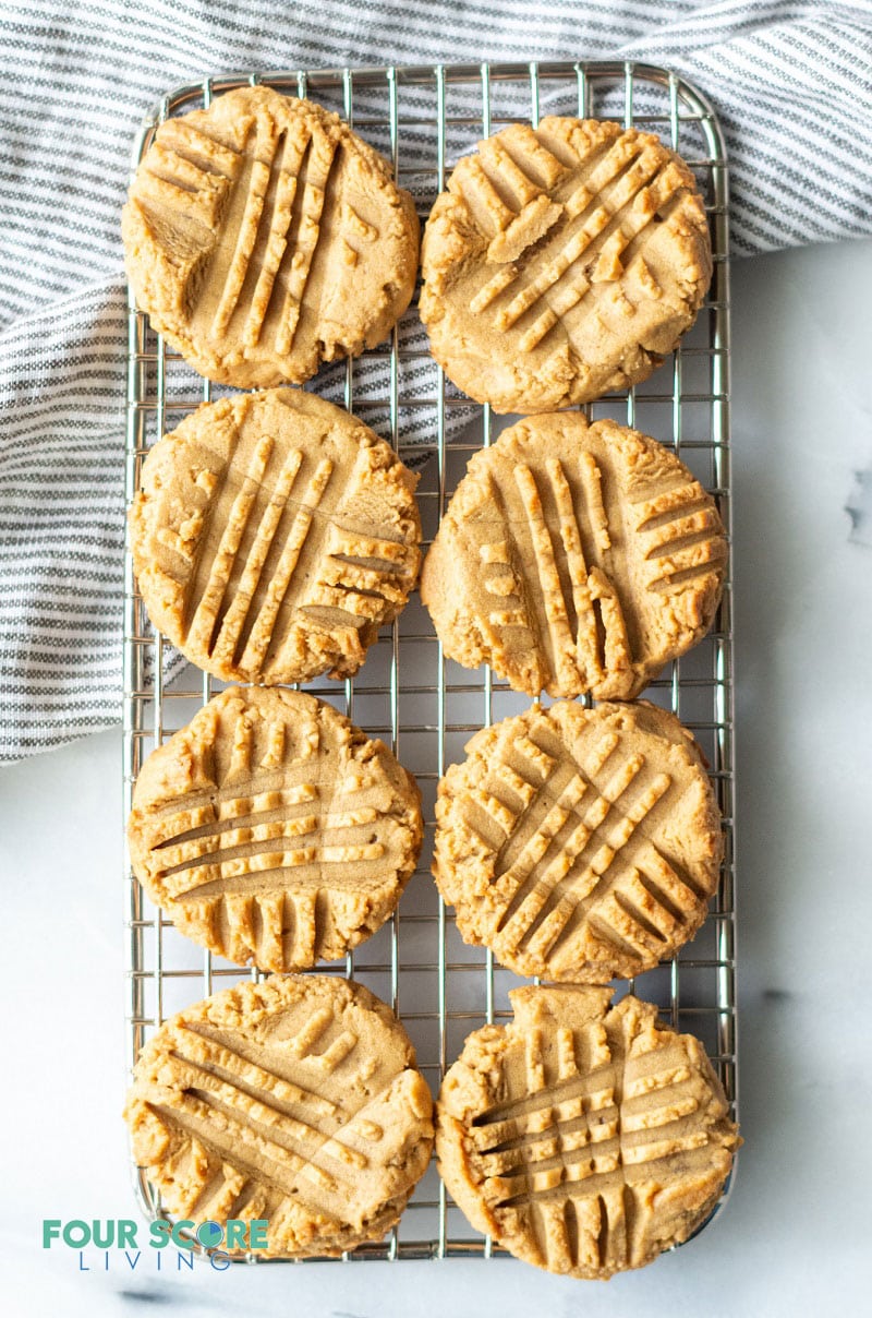 eight peanut butter cookies cooling on a wire rack
