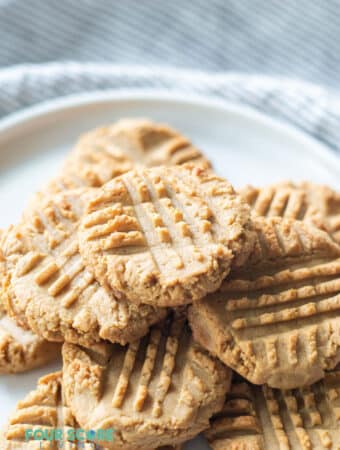 a pile of peanut butter cookies on a round white plate