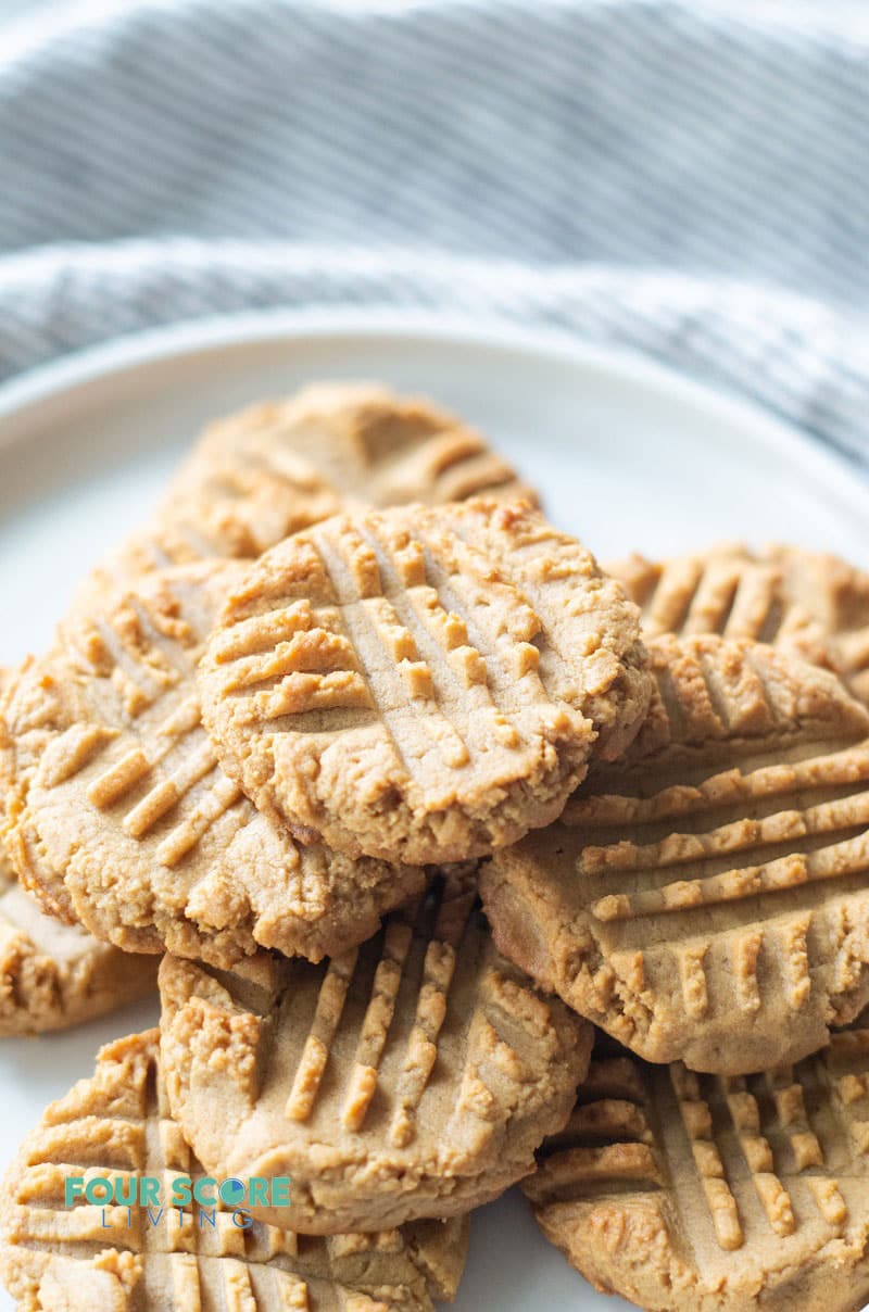 a pile of peanut butter cookies on a round white plate