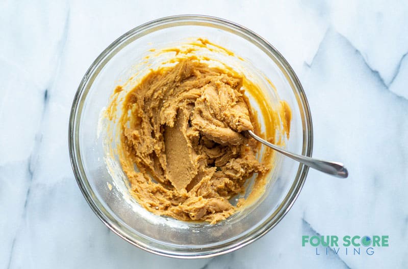 a clear bowl filled with peanut butter cookie dough