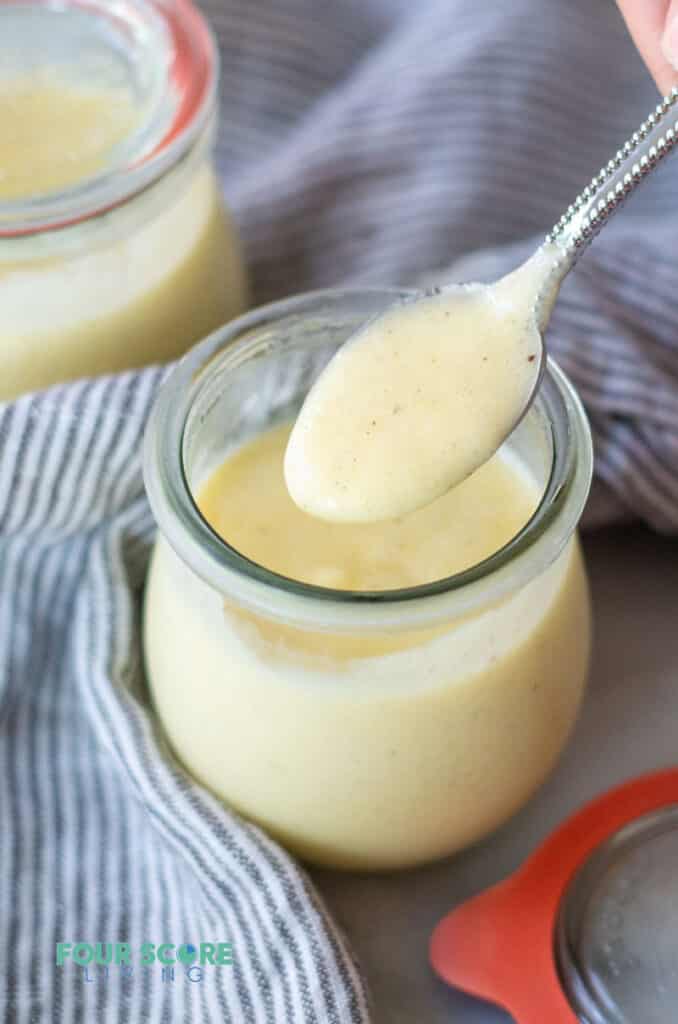 a spoonful of keto pudding over a jar of keto pudding