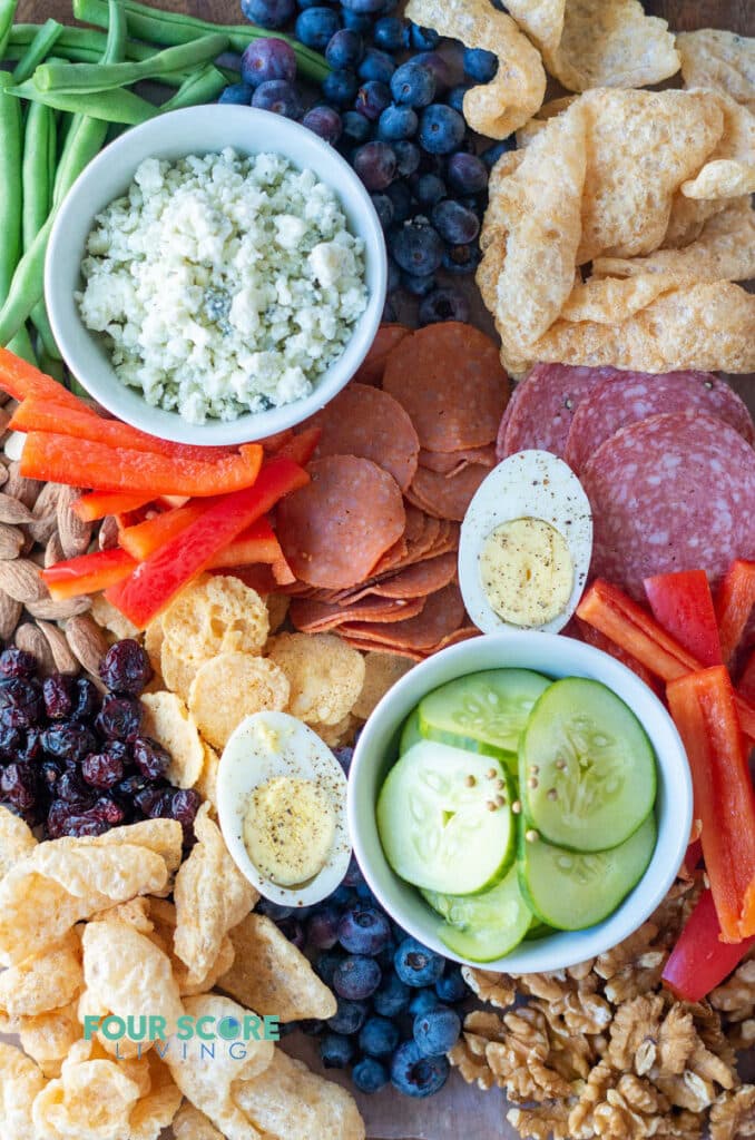 meats, cheeses, nuts, fruits on a keto charcuterie board