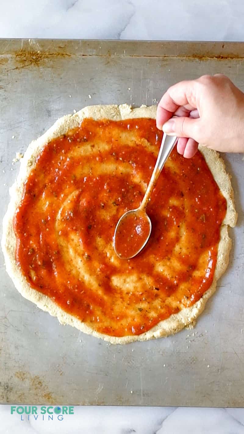 keto pizza sauce on a a pizza crust