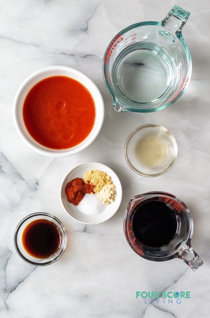 Top down shot of ingredients for BBQ sauce in separate bowls. 