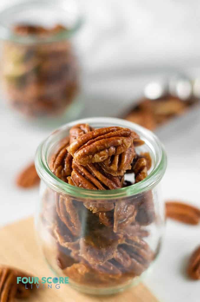 a glass jar of keto candied pecans
