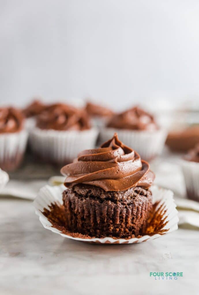 a keto chocolate cupcake with the wrapper peeled back