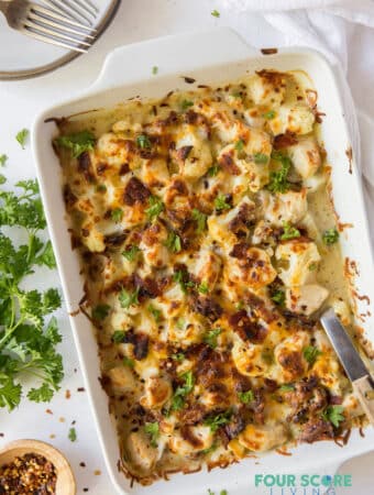 Rectangle casserole dish full of chicken bacon ranch casserole with cauliflower, on a table.