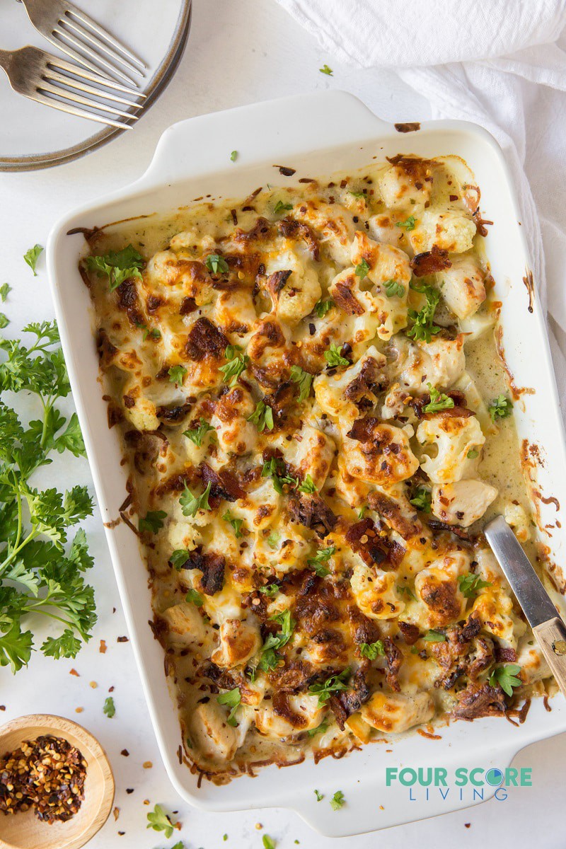 Rectangle casserole dish full of chicken bacon ranch casserole with cauliflower, on a table.