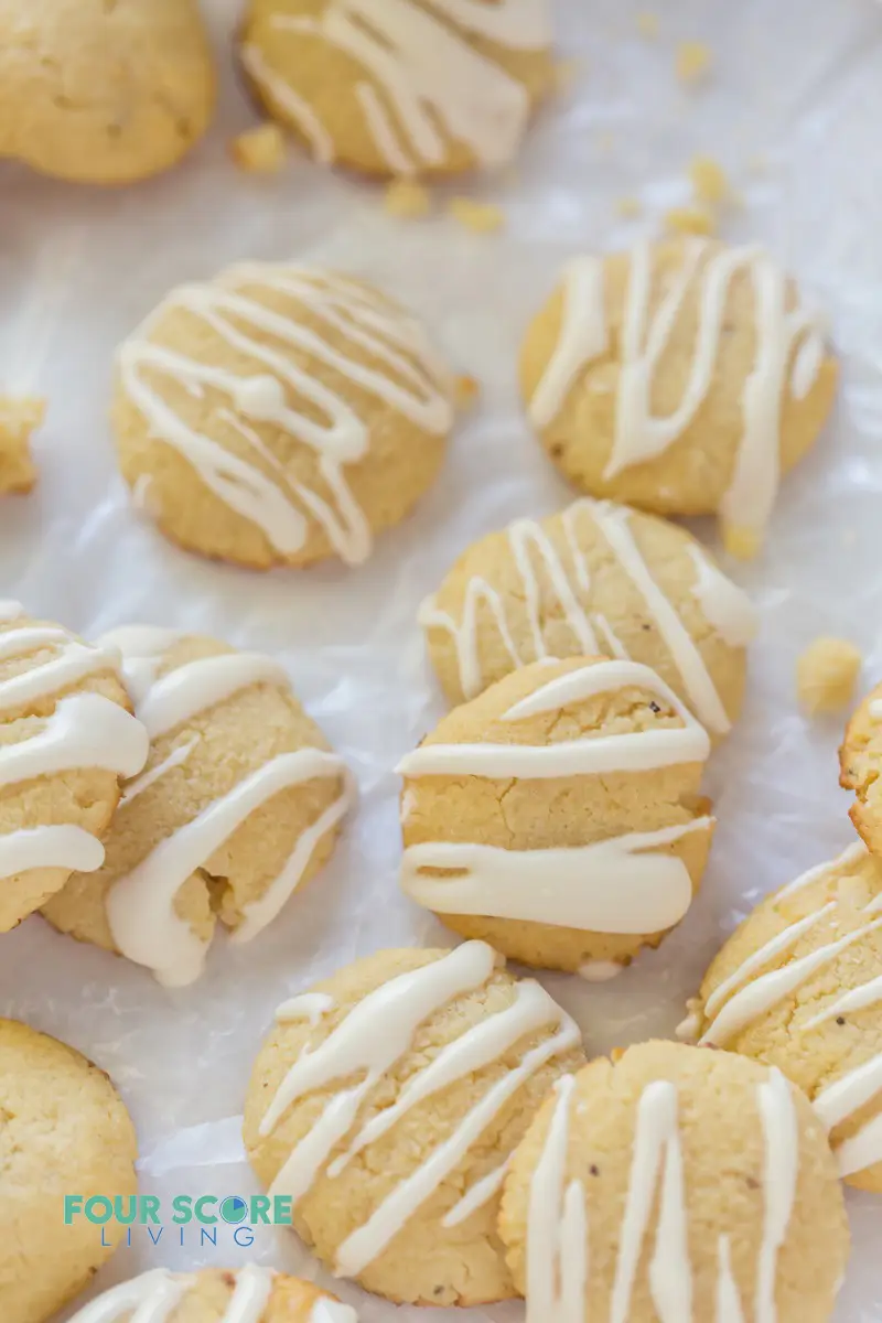 close up of round cookies with white drizzled icing.