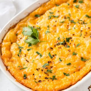 a cheesy breakfast casserole in an oval casserole pan.