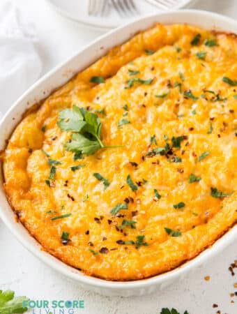 a cheesy breakfast casserole in an oval casserole pan.