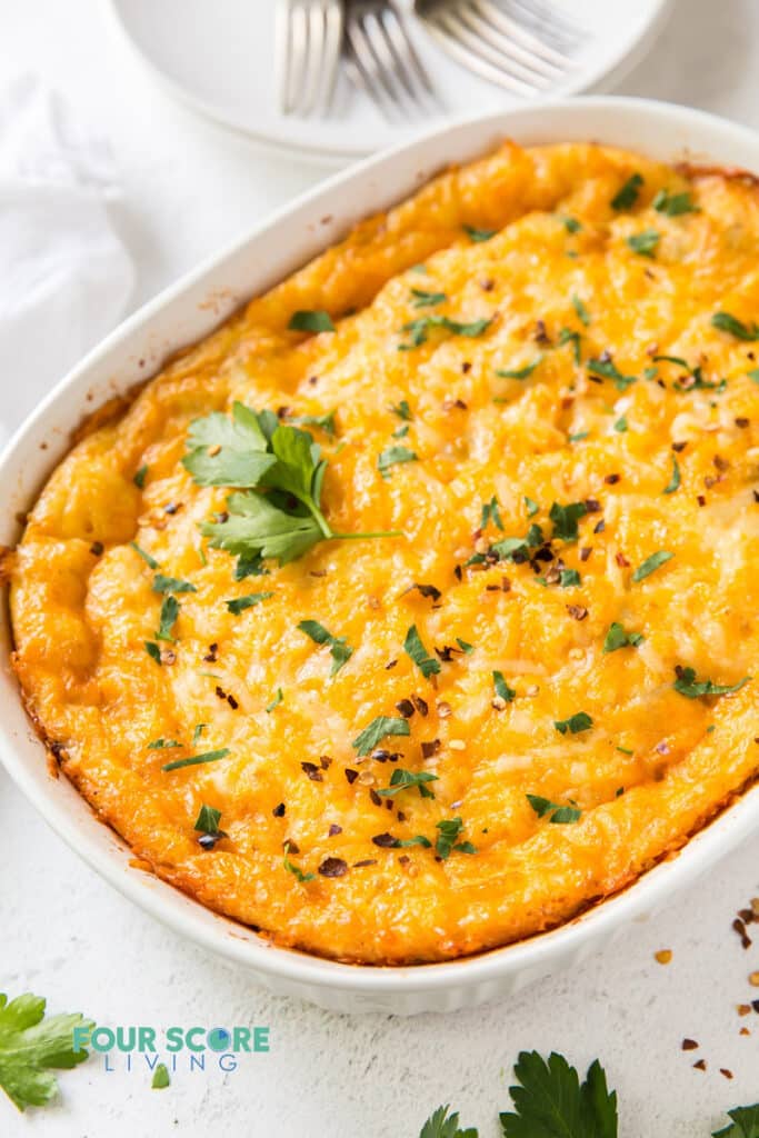 a cheesy breakfast casserole in an oval casserole pan.