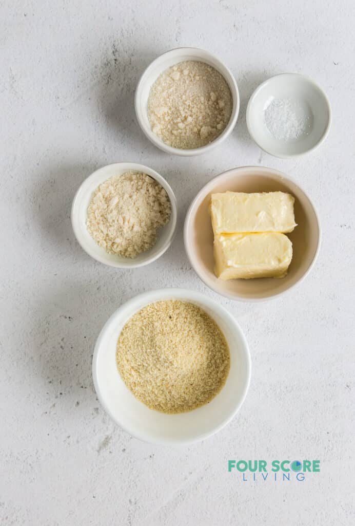 Top down view of ingredients needed to make lemon bar crust, including flours and butter.