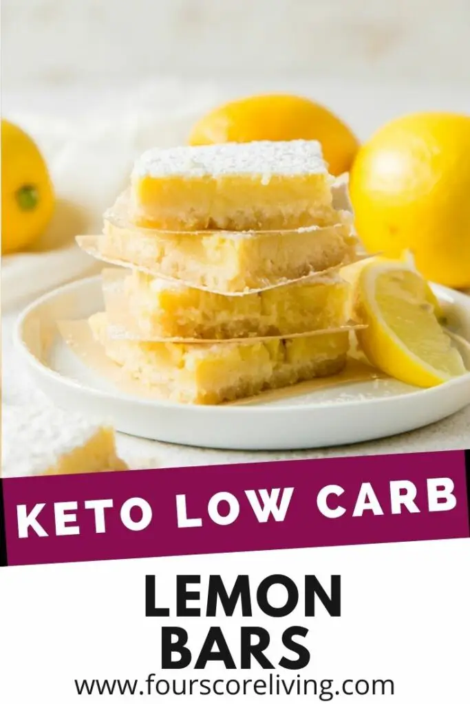 a plate of four lemon bars, surrounded by lemons.