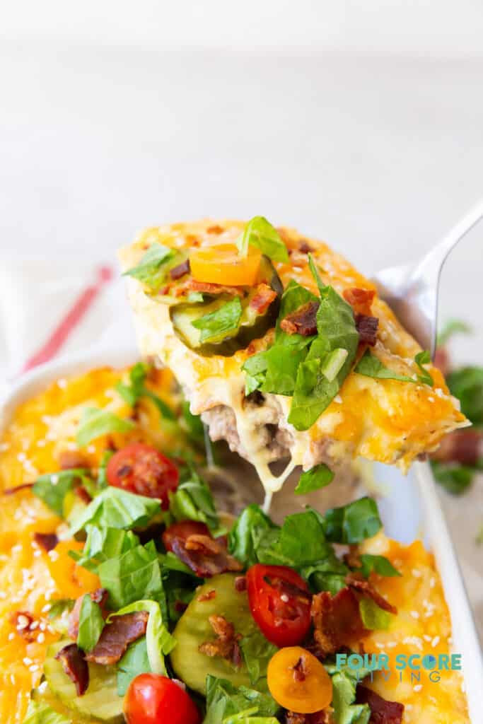 a casserole dish with keto cheeseburger casserole being served.